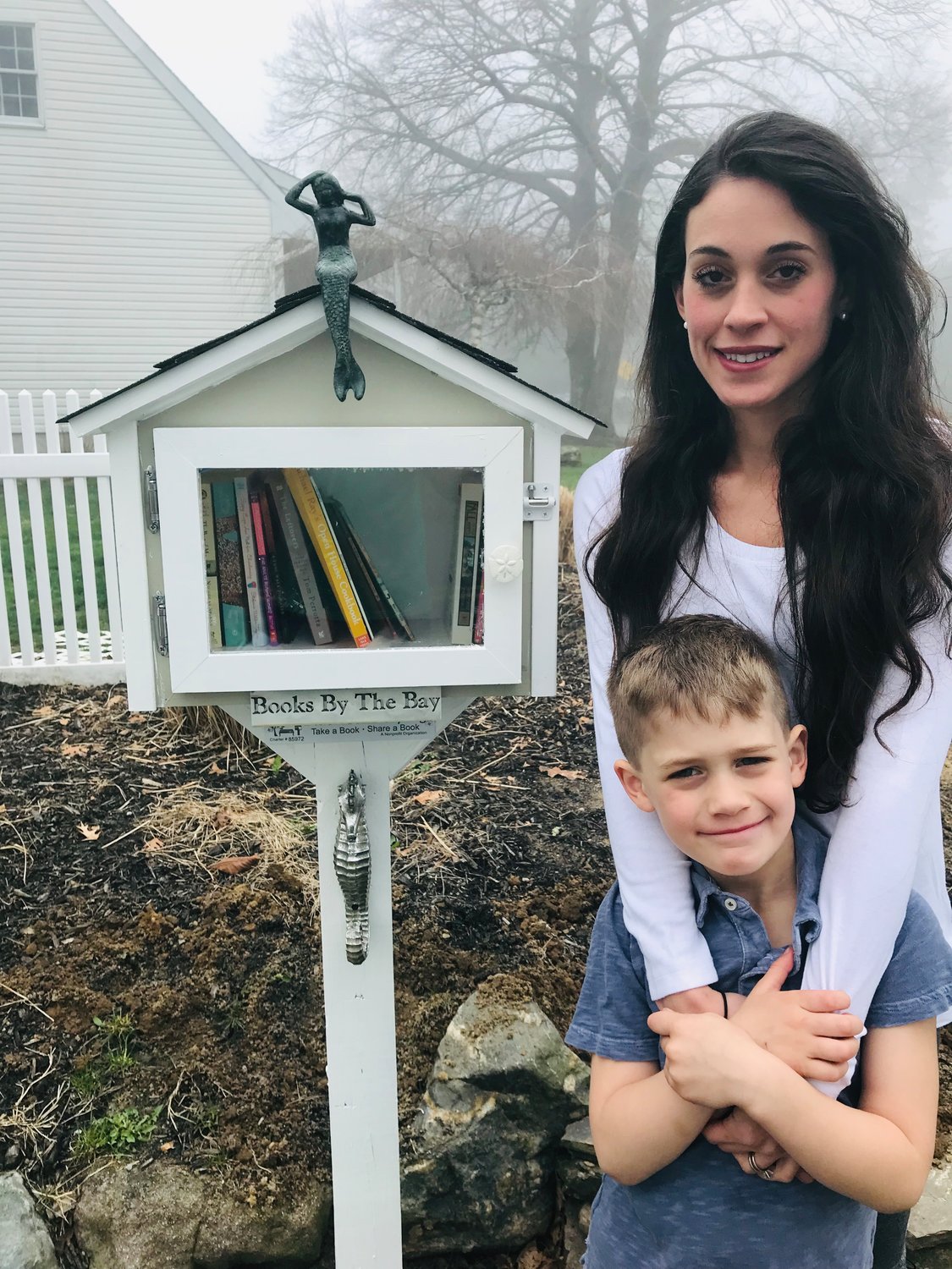 Cassandra Levy with her son, Bryce, at the “little free library” she installed in her neighborhood in Center Moriches. 
